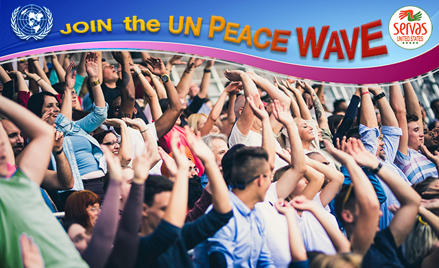 photo of people at a stadium doing "the wave" with a banner that reads Join the UN Peace Wave"