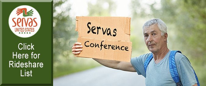Photo of hitchhiker holdin cardboard sign "Servas Conference"